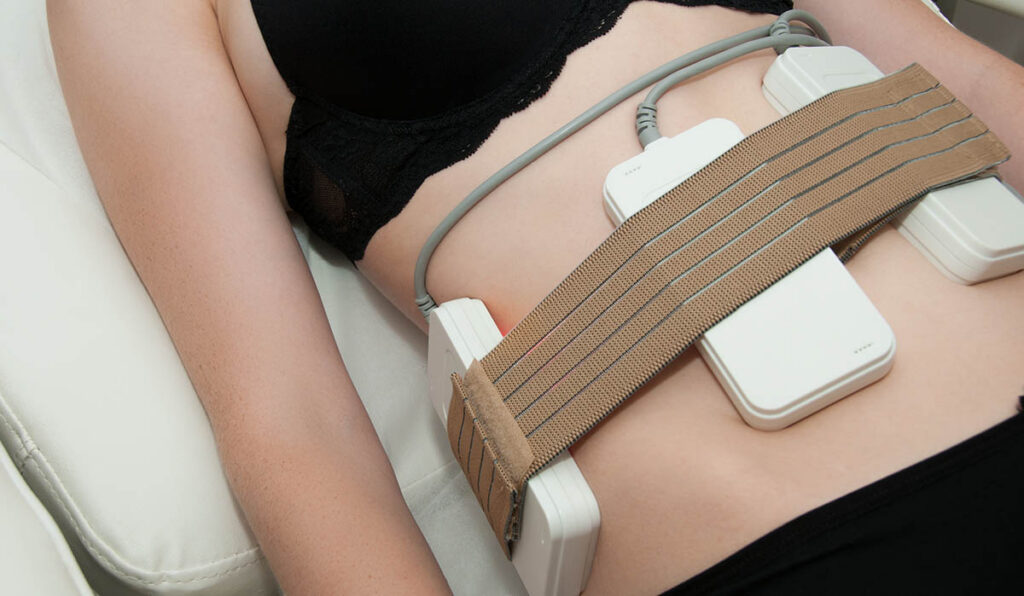 Pretty young woman on laser liposuction in cosmetic cabinet